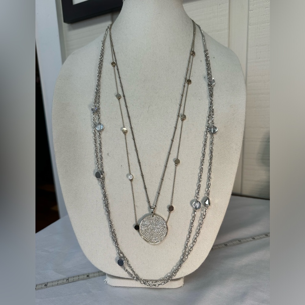Three long silvertone and goldtone necklaces